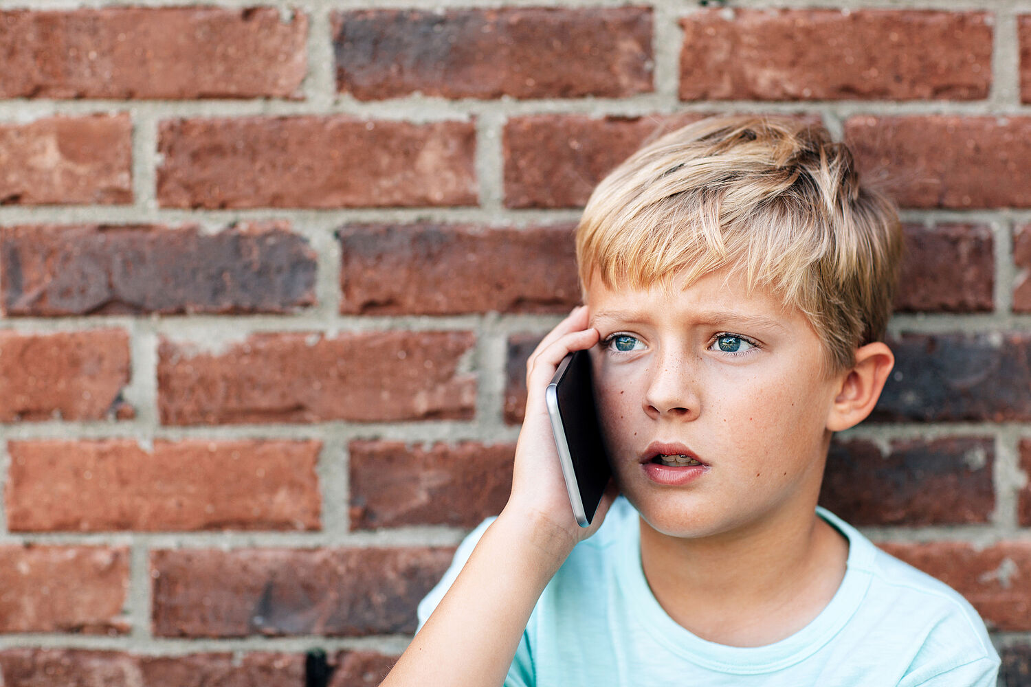 Ein Junge am Handy telefoniert 